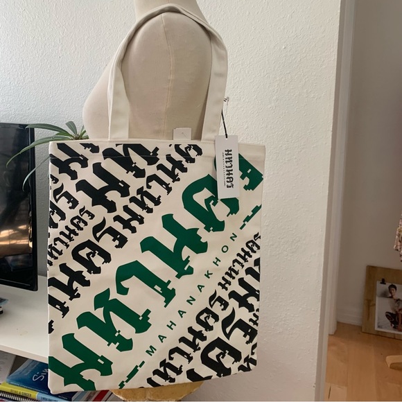 Mahanakhon Tote Bag with green and black font on cream canvas. Pushbutton close - Picture 1 of 6